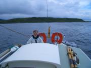 CIMG0401 Skipper at the helm, steering us through the choppy waters of the Cuan Sound